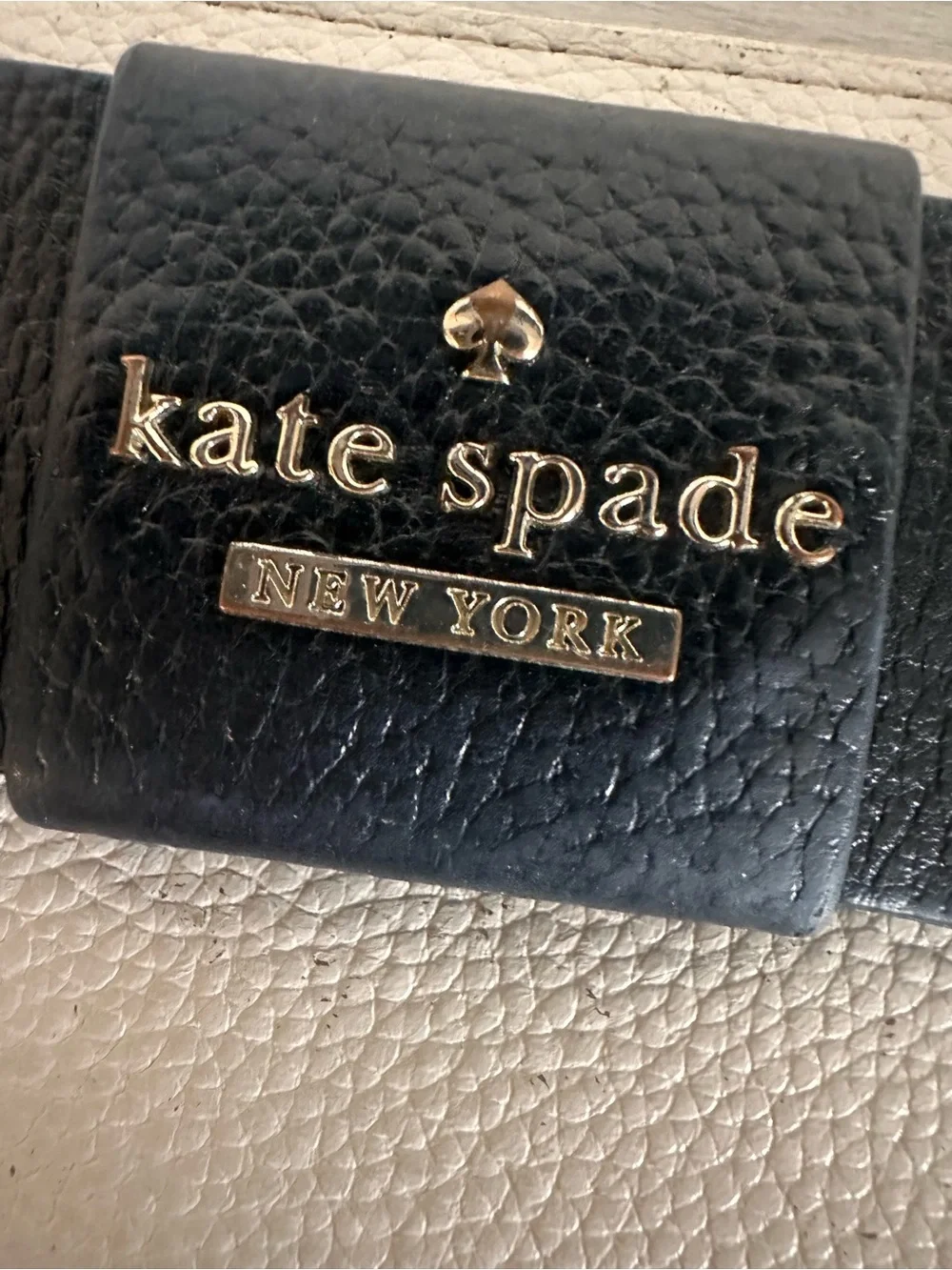 kate spade cream zip-around wallet with black bow detail